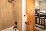 The bunk room ensuite offers a full-sized bath tub.